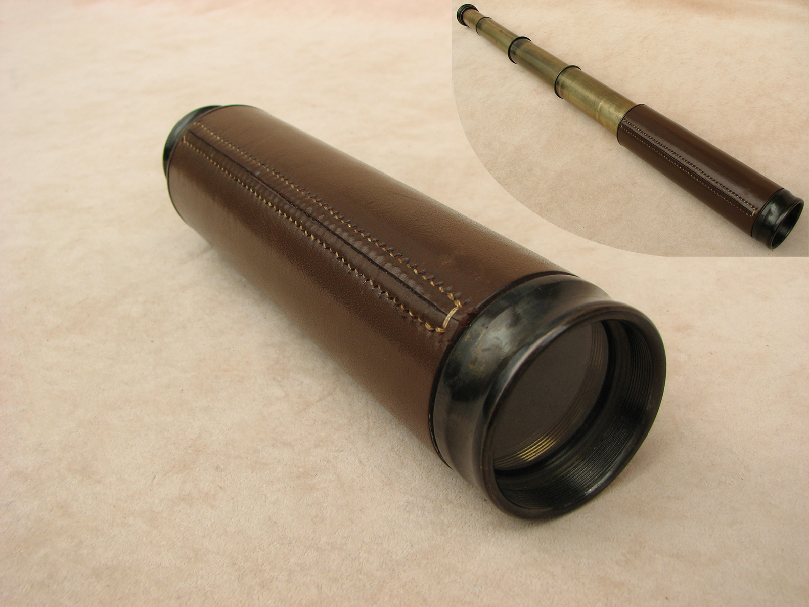 3 draw leather clad pocket telescope with pancratic tube to 20x magnification.